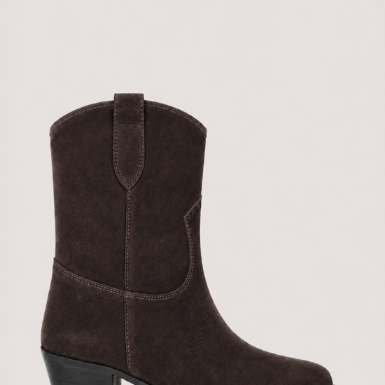 A dark brown suede western-style ankle boot with a low block heel, shown from a side profile against a light gray background.