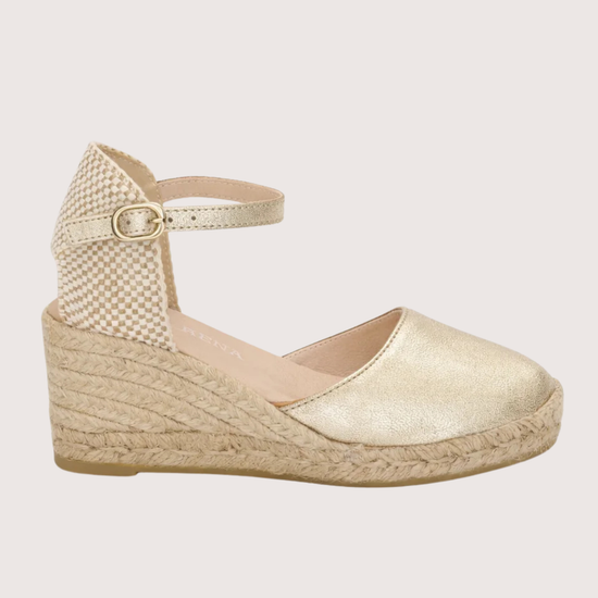 gold espadrille sandal on a white background 