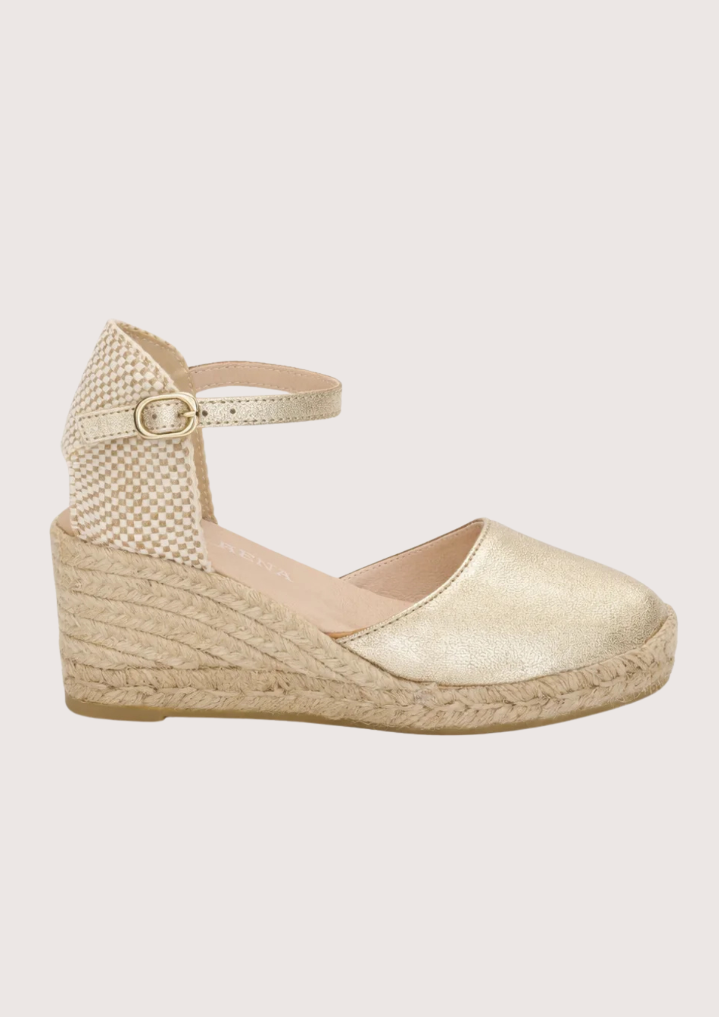 gold espadrille sandal on a white background 