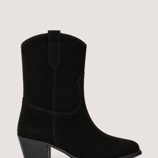 A black suede western-style ankle boot with a low block heel, shown from a side profile against a light gray background.
