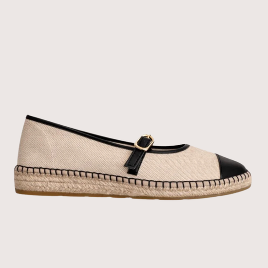 Beige flat shoe with black cap-toe and woven sole 