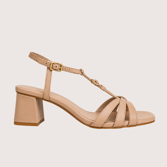 Beige sandal with a block heel on a light beige background