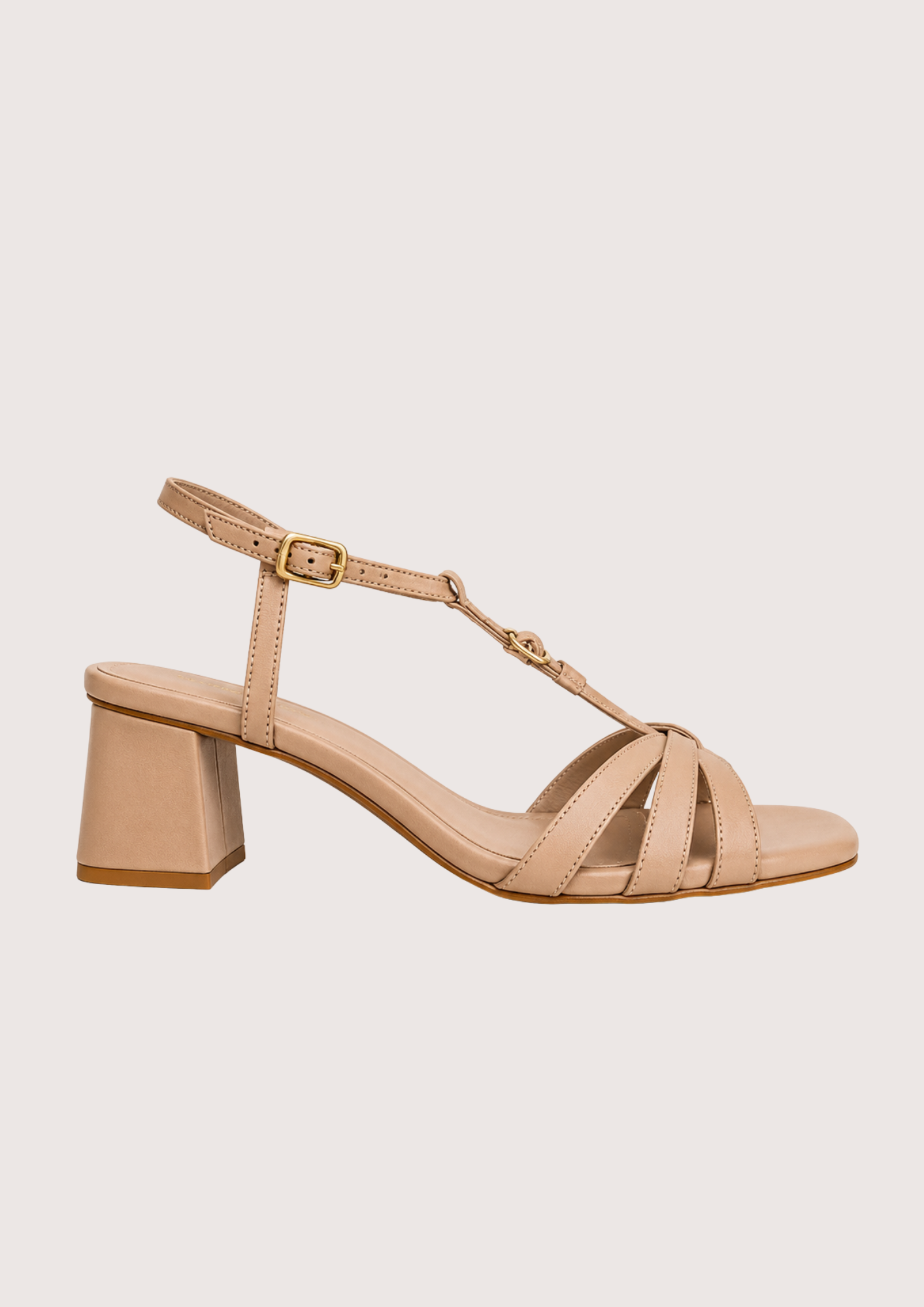 Beige sandal with a block heel on a light beige background
