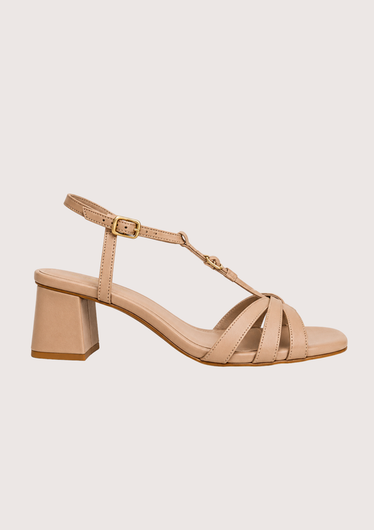 Beige sandal with a block heel on a light beige background