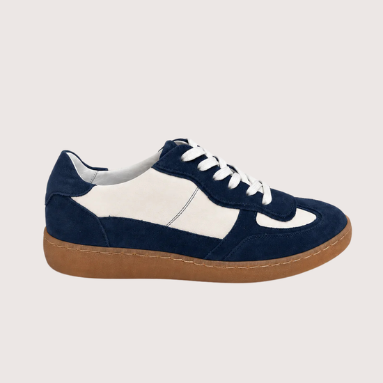 navy and white trainer with a gum sole on a white background