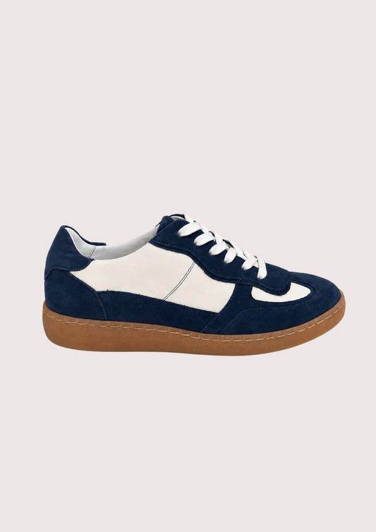 navy and white trainer with a gum sole on a white background