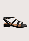 Black sandal with gold hard ware on a white background