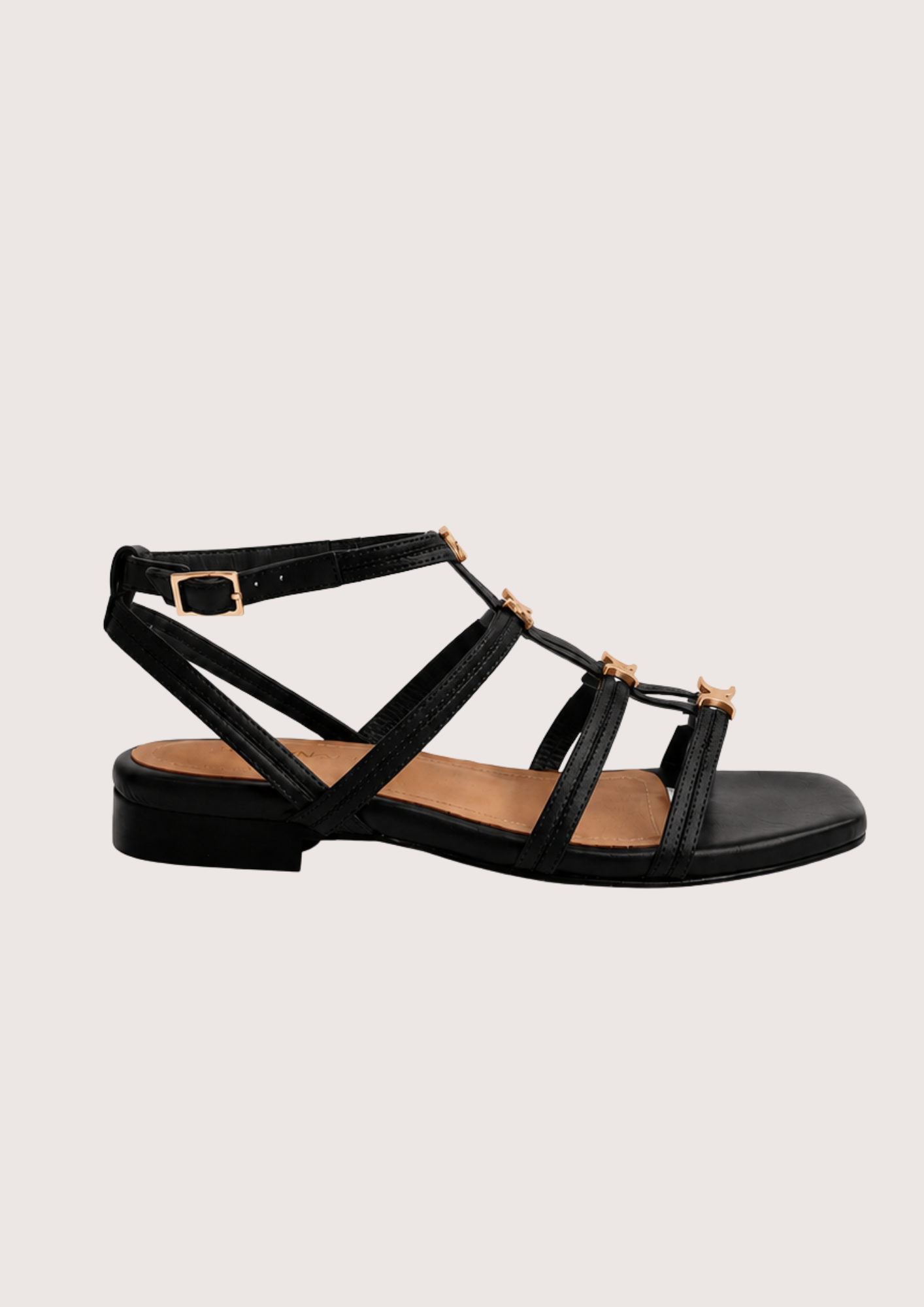 Black sandal with gold hard ware on a white background