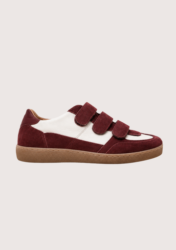 burgundy trainer with velcro straps on a white background