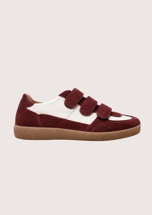 burgundy trainer with velcro straps on a white background