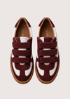 burgundy and white velcro trainer on a white background