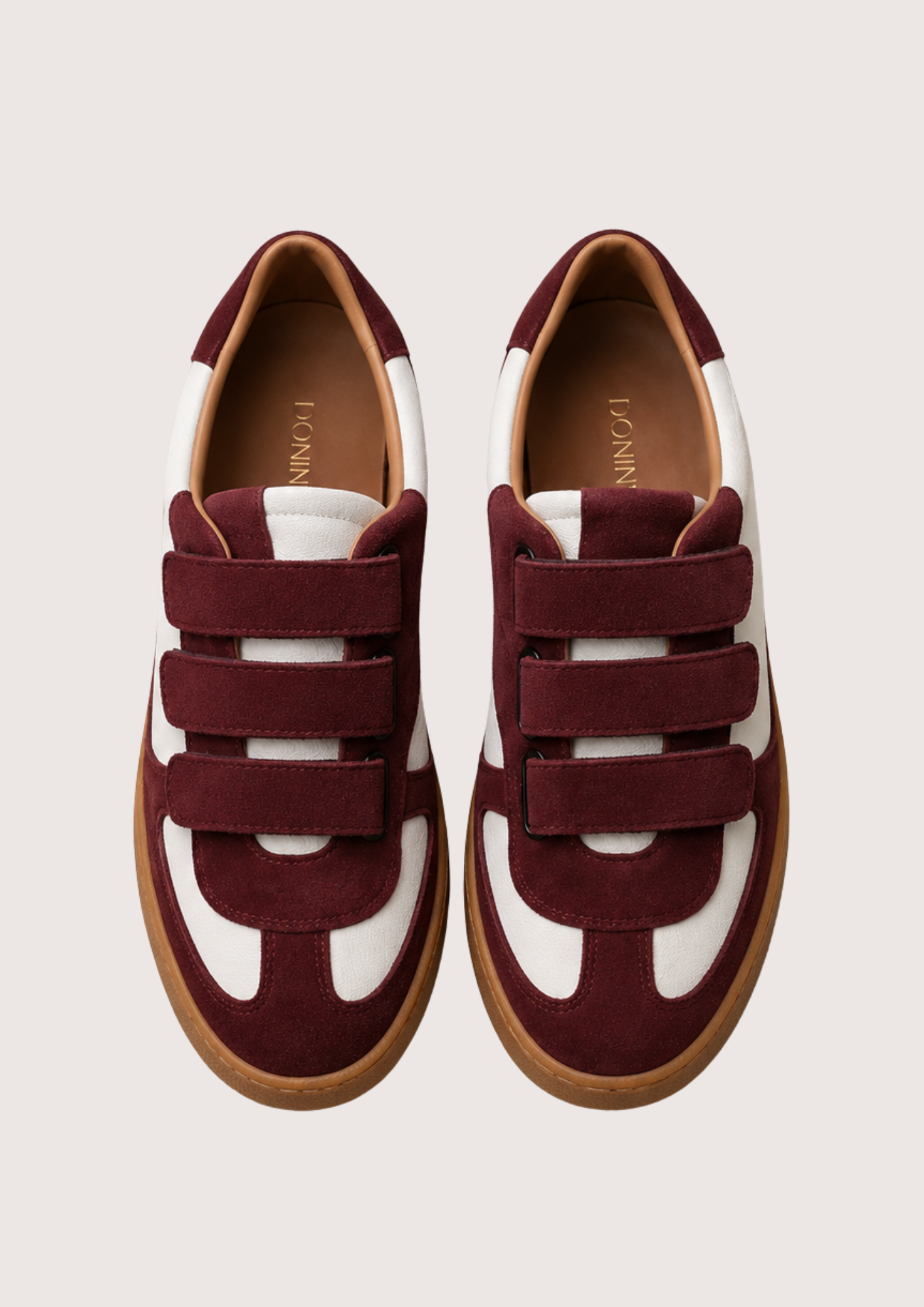burgundy and white velcro trainer on a white background