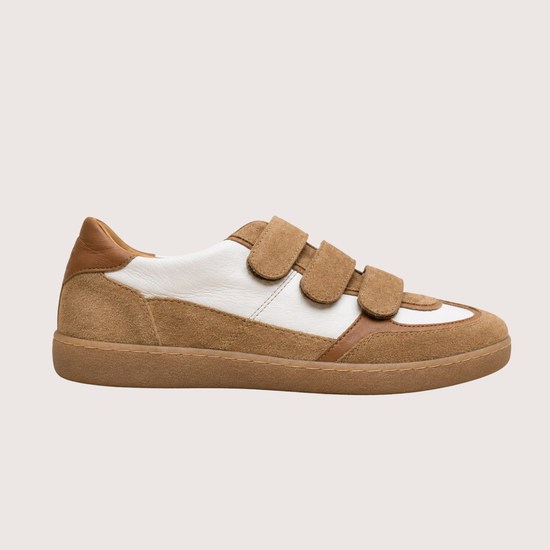 tan trainer with velcro straps on a white background