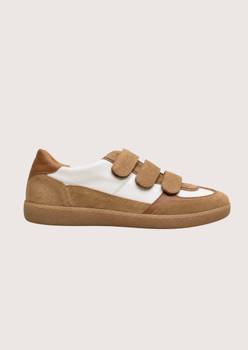tan trainer with velcro straps on a white background