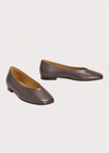 A pair of women's pointed-toe flats in smooth taupe-brown leather, displayed on a light gray background.