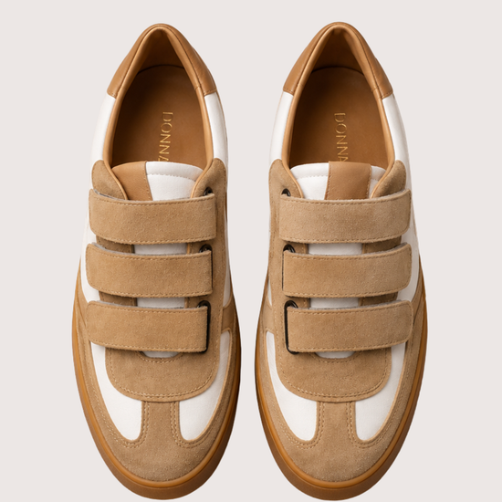 tan trainer with velcro straps on a white background