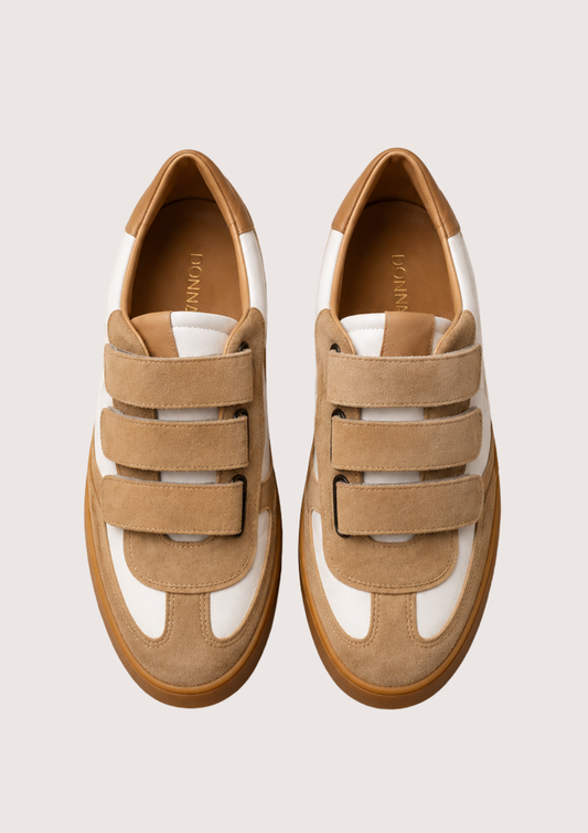 tan trainer with velcro straps on a white background