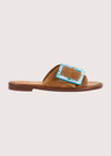 Brown sandal with a blue buckle on a white background