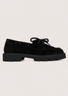 flat lay image of a chunky black suede loafer on a white background