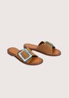 Tan suede sliders with a turquoise buckle detail