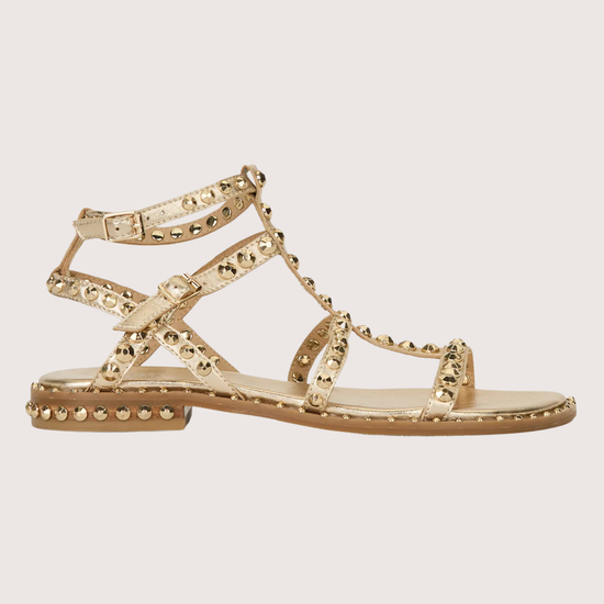 Gold sandal with gold studs on a white background side profile 