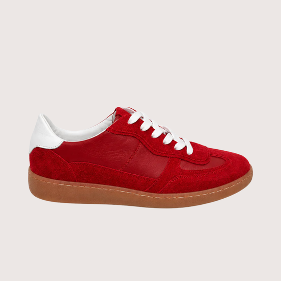 red trainer with a gum sole on a white background