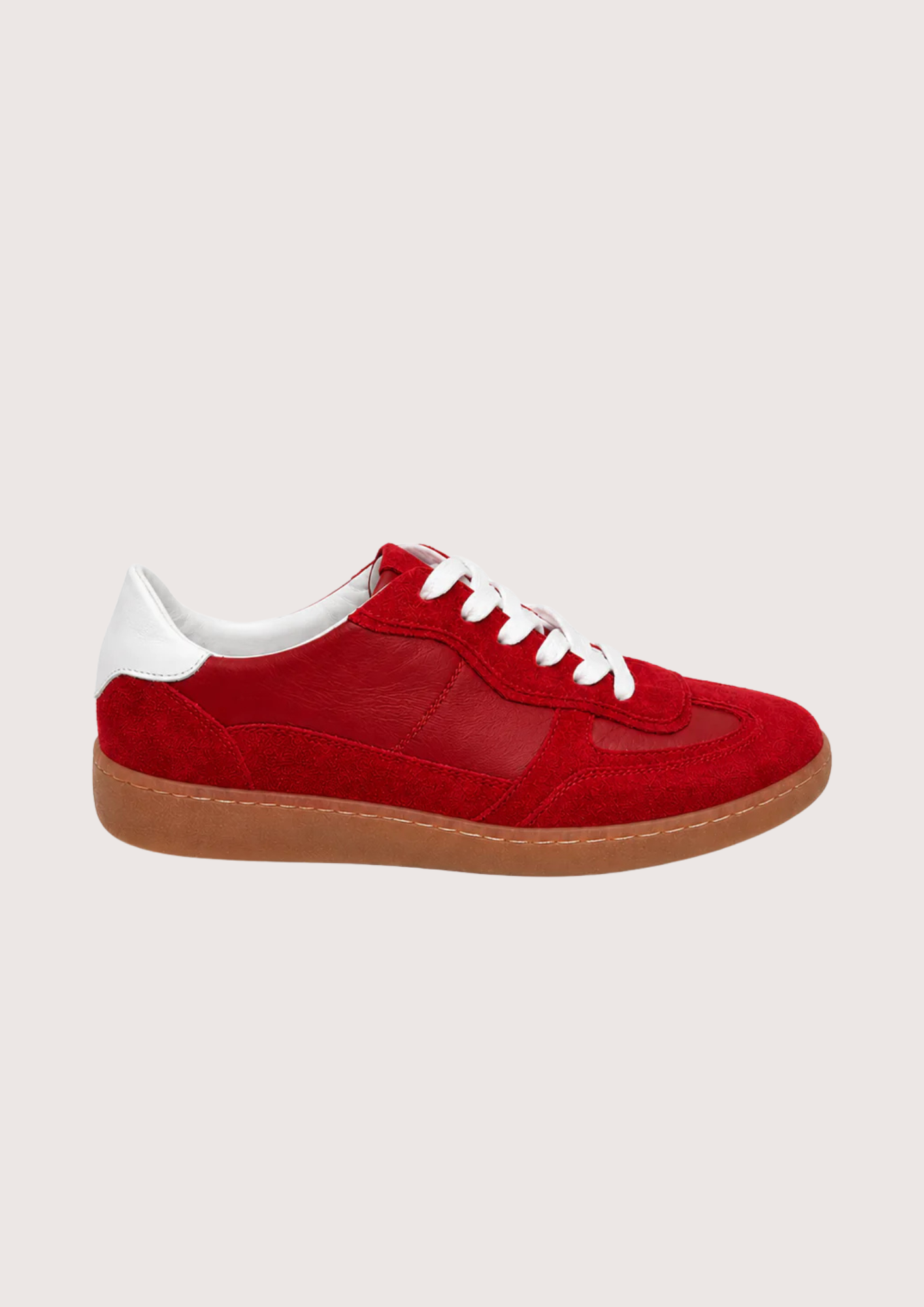 red trainer with a gum sole on a white background