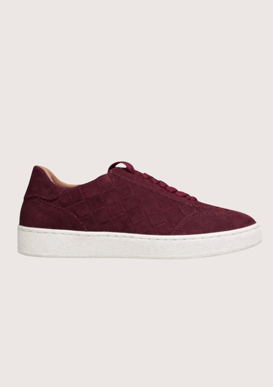 woven burgundy trainer with a white sole on a white background