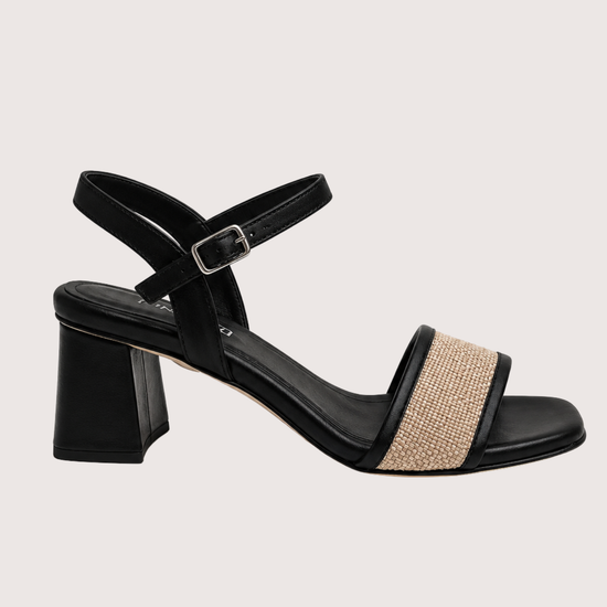 Black block heel sandal with a raffia toe on a white background