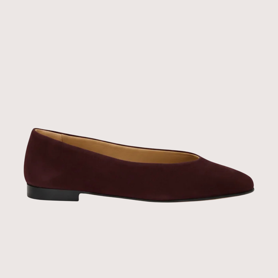Burgundy suede flat shoe on a white background