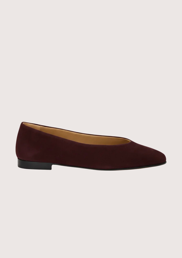 Burgundy suede flat shoe on a white background
