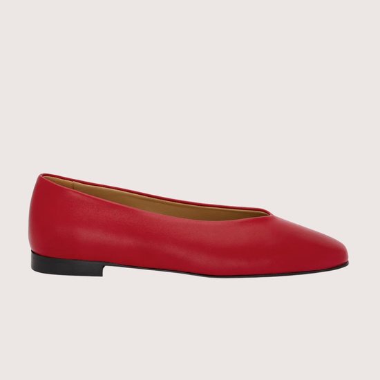 Red leather flat shoes on a light gray background