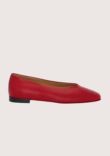 Red leather flat shoes on a light gray background