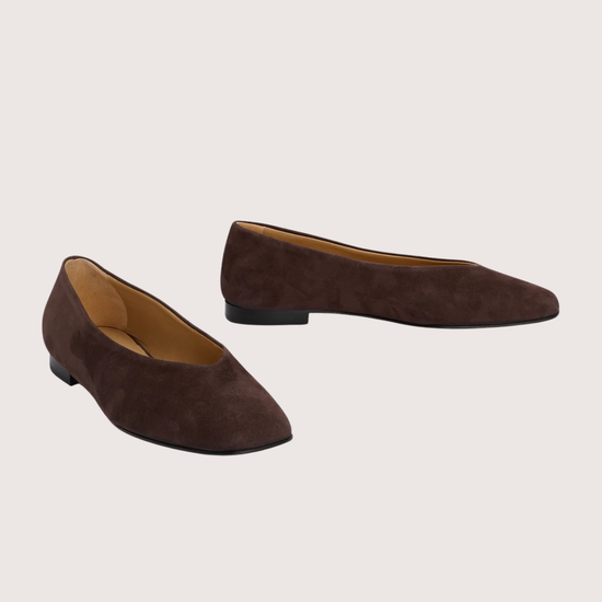 Pair of brown suede shoes on a light gray background