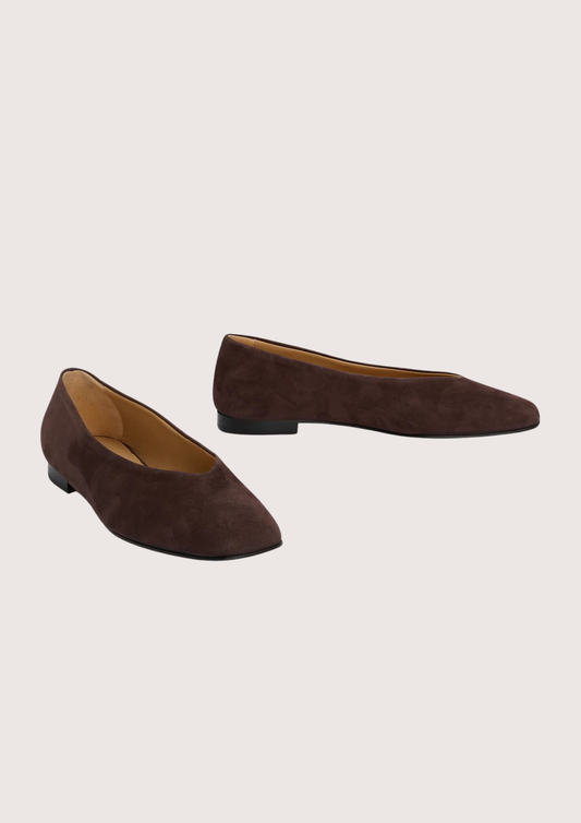 Pair of brown suede shoes on a light gray background