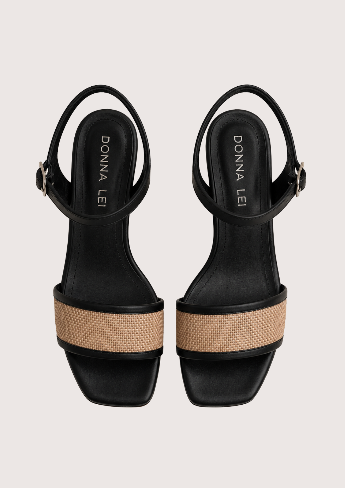 Black sandals with raffia across the toe on a white background
