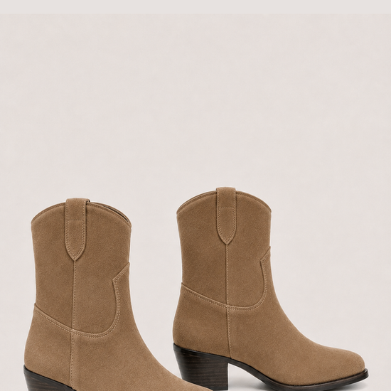 A pair of women's mid-calf boots in tan suede, featuring a stacked block heel and a pull tab at the back of the collar, shown against a light beige background.