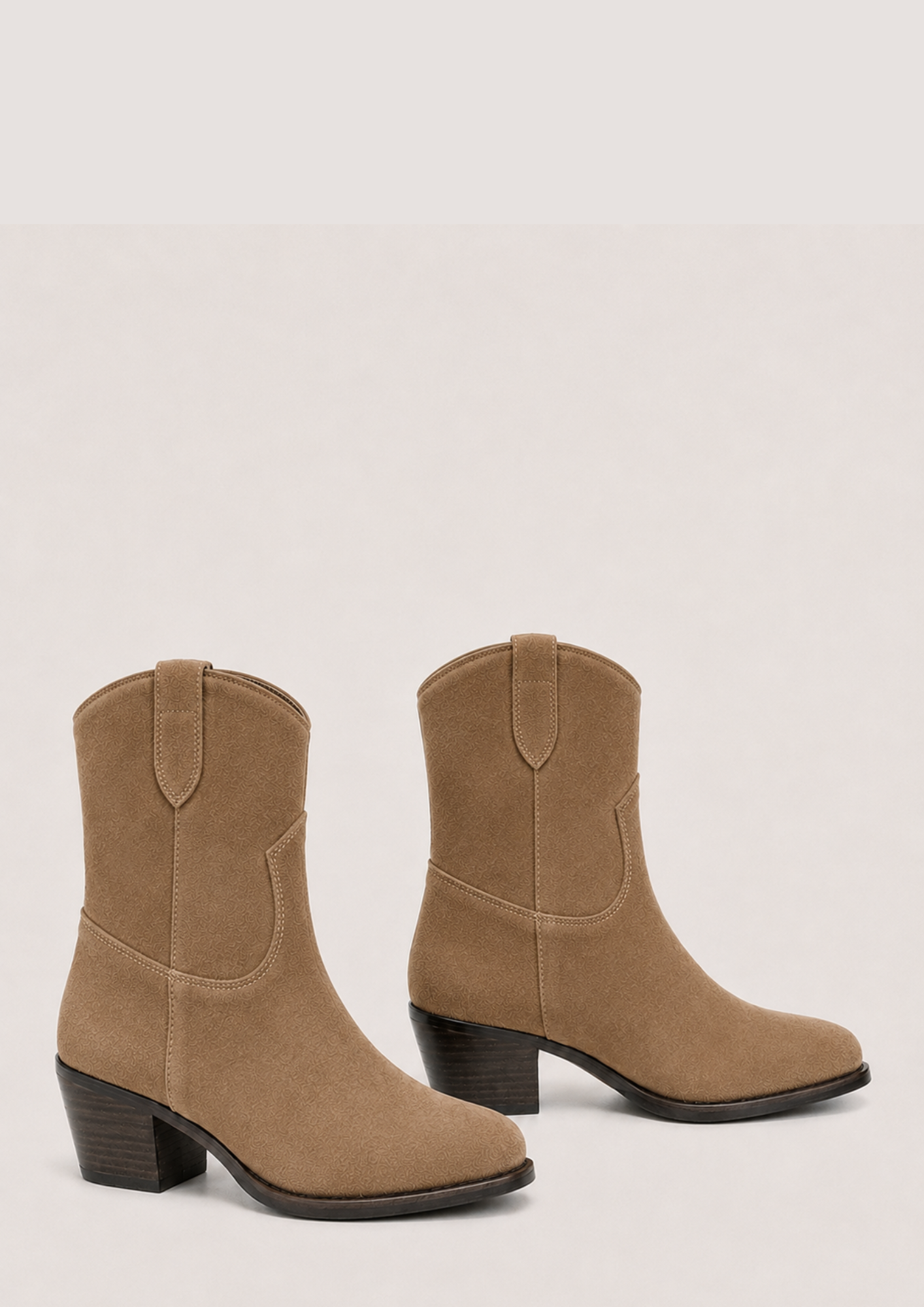 A pair of women's mid-calf boots in tan suede, featuring a stacked block heel and a pull tab at the back of the collar, shown against a light beige background.