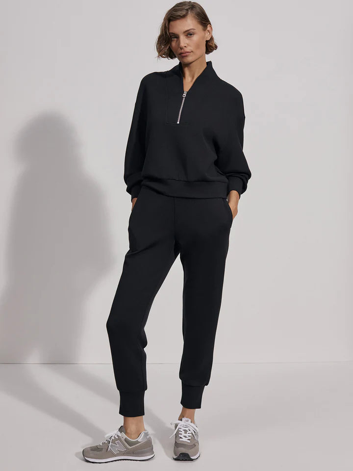 Quarter zip and slightly cropped black sweat top with shawl collar and V necklin