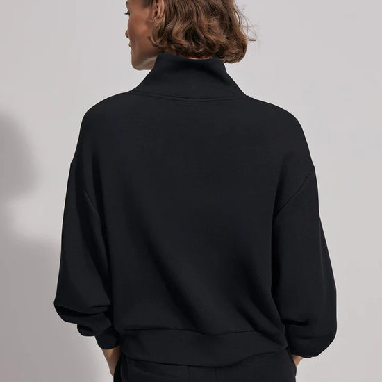 Quarter zip and slightly cropped black sweat top with shawl collar and V necklin