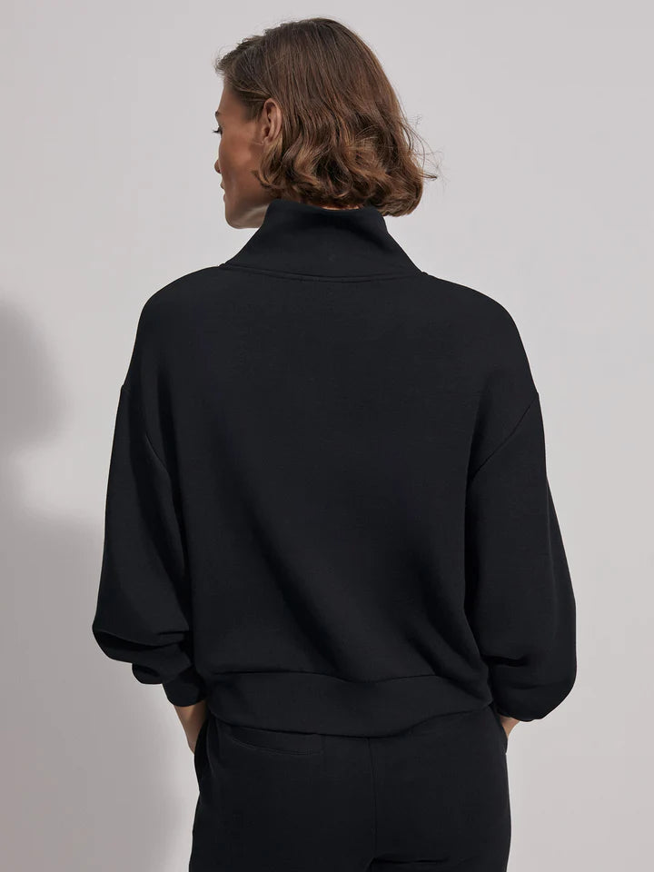 Quarter zip and slightly cropped black sweat top with shawl collar and V necklin