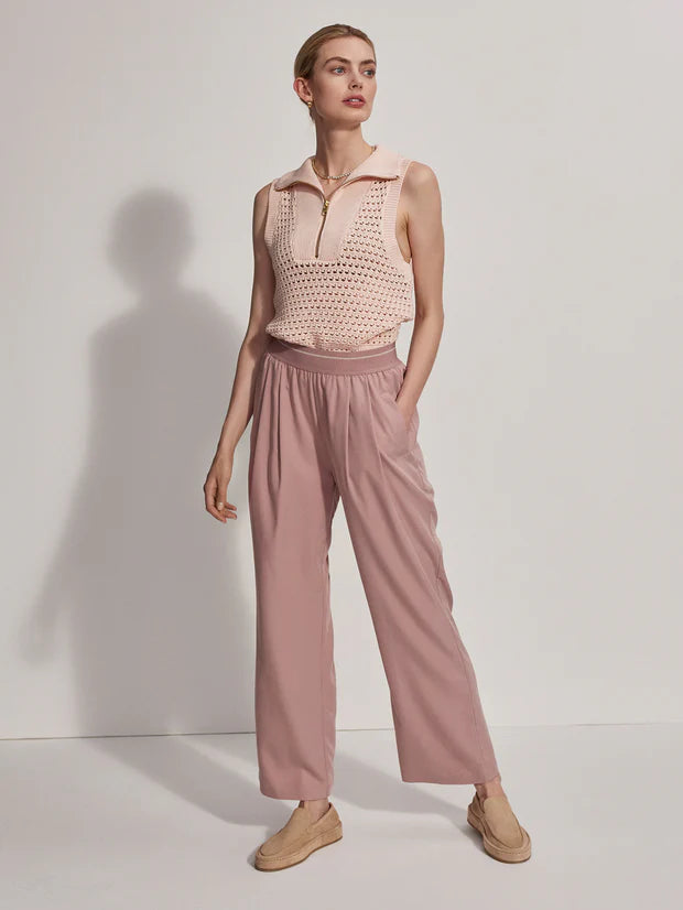 Pink pull on trousers with an elasticated waistband and side pockets model shot