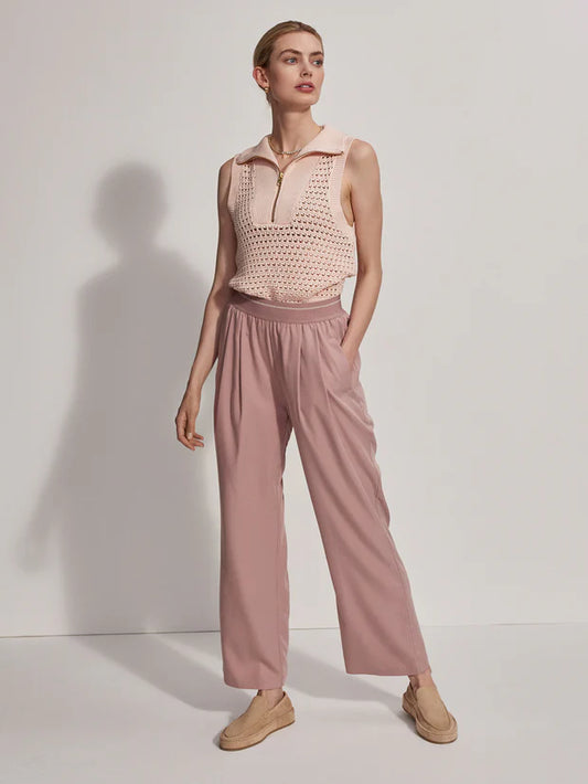 Pink pull on trousers with an elasticated waistband and side pockets model shot