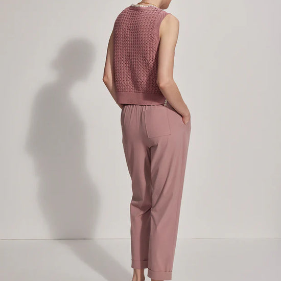 Pink pull on trousers with an elasticated waistband and side pockets rear view