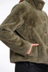 green faux fur short jacket with stand collar from rino and pelle close up