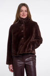 Woman wearing a brown fur coat on a white background