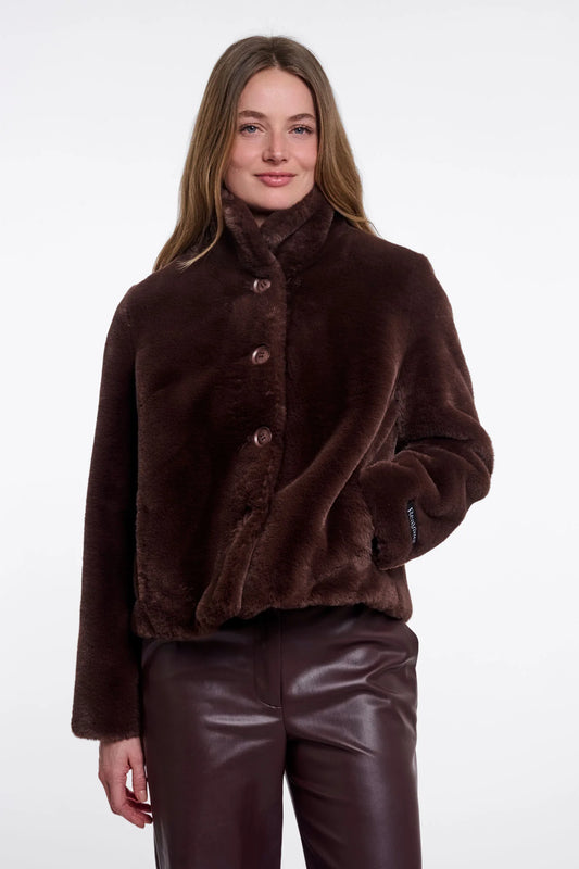 Woman wearing a brown fur coat on a white background