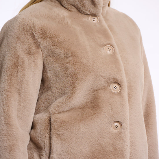 Short faux fur jacket with oatmeal hue, beige buttons and high neck side view