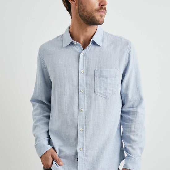 light blue shirt with chest pocket and curved hem