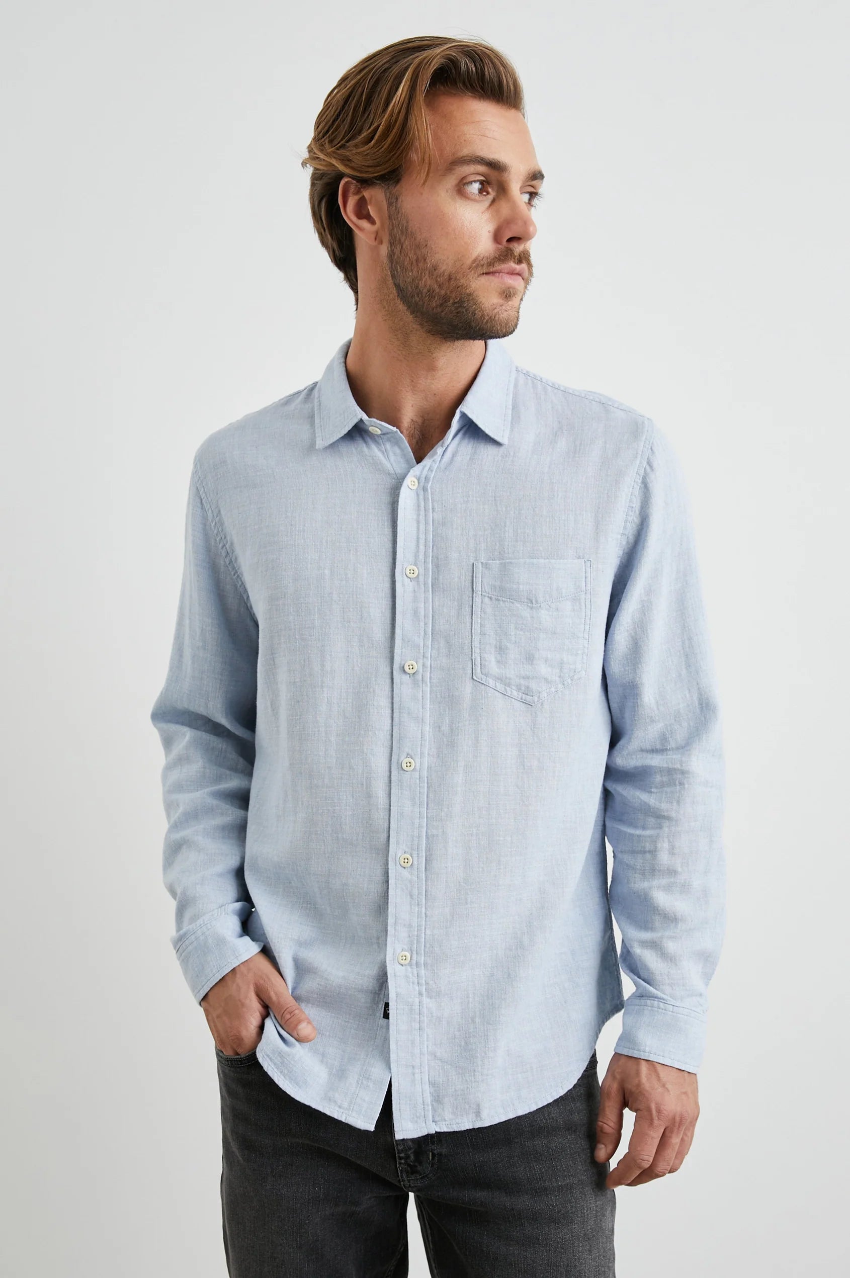 light blue shirt with chest pocket and curved hem